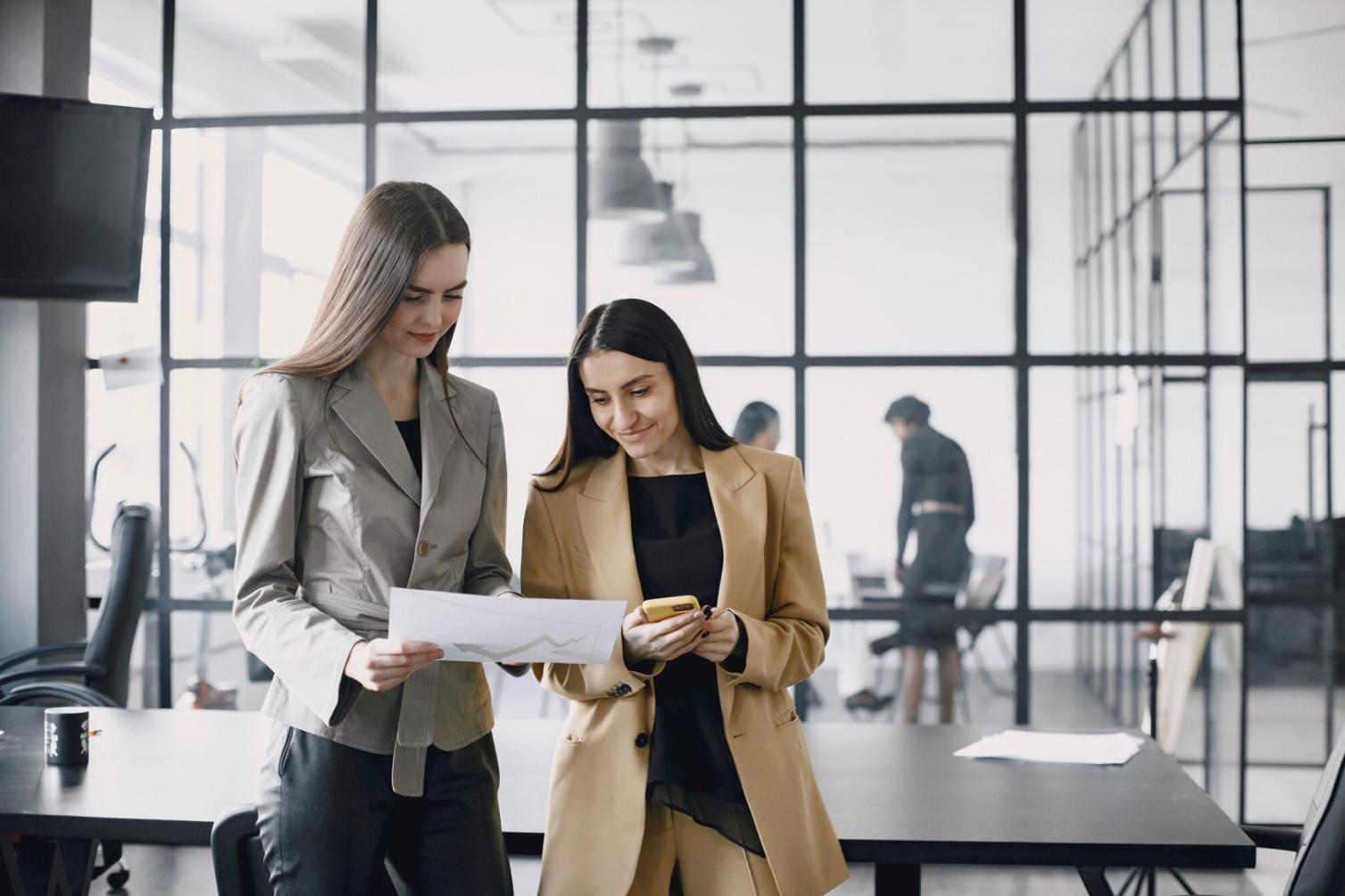 Financial analyst reviewing budget deviation reports with charts and data visualizations